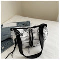 Detailed macro view of ink landscape pattern on lightweight pleated crescent crossbody bag - Black