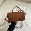 Vintage brown leather crossbody bag with dual decorative round buckles and top handle - Tan