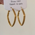 Detailed view of gold geometric hoop earrings with contrasting matte and polished textures - Gold