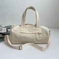 Cylindrical beige sports duffel bag with textured fabric and adjustable strap - White