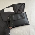 Elegant black envelope clutch bag featuring silver studs and detachable wrist strap - Black