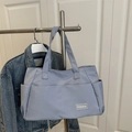 Light blue nylon tote bag for women showing spacious design and durable shoulder straps - Blue