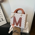 Minimalist tote bag with M-letter pattern and brown leather accents for women - White