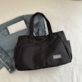 Durable black nylon tote bag with multiple pockets and fashion label for daily commute - Black