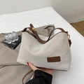Chic beige knitted canvas tote with brown leather straps and metallic zipper details - Brown