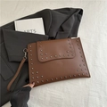 Brown leather envelope clutch bag with dark square metal rivets and wrist strap - Brown
