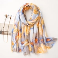 Close-up of floral print linen scarf with tulip patterns and delicate frayed edges - Yellow