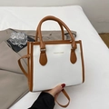 White lychee pattern crossbody handbag with brown contrast straps and gold lettering - White