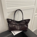 Retro deep brown large tote bag in shiny faux leather with buckle detail on a chair - Brown