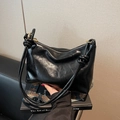 Large black glossy retro tote bag with unique knot straps and detailed leather texture - Black