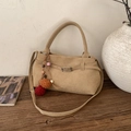 Vintage khaki suede tote bag with bohemian tassel charm on a rustic wooden table - With Pendant / Khaki