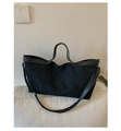 Detail of black canvas tote bag with leather trim, silver hardware and adjustable strap - Black