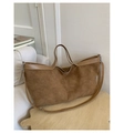 Close-up of brown suede tote bag with leather handles and strap on a wooden stool - Khaki
