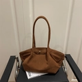 Brown frosted suede large tote bag with slim straps on a black chair for daily commute - Brown