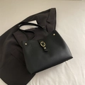 Classic black faux leather tote bag with elegant gold metal buckle and studs - Black