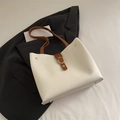 White leather tote bag with brown straps and gold hardware for office commuting style - White