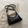 Sleek black glossy hobo underarm bag with silver buckle and vintage biker accents - Black