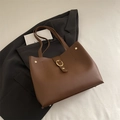 Retro dark brown matte leather tote bag with gold ring buckle and rivets on black suit - Brown