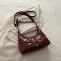 Glossy burgundy underarm bag in patent leather with silver buckle and crescent shape - Red