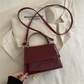 Retro wine red patent leather handbag with adjustable crossbody strap in stylish layout - Red