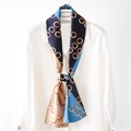 Elegant geometric ring pattern narrow silk scarf styled on a white collared shirt - Blue