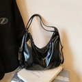 Glossy black hobo bag in oil wax finish with adjustable straps on vintage books - No Pendant / Black
