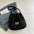 Black pleated tote bag with silver metal bow accent and drawstring bucket design - Black