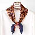 Classic leopard print silk square scarf tied on white shirt with gold pearl pendant - Deep Coffee Blue
