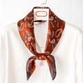 Elegant silk-like paisley square scarf in rust red tied on a white blouse for women - Orange Red