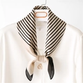 Detail of elegant beige and black striped silk scarf with a heart pearl brooch on white shirt - 70cmx70cm / Khaki