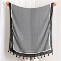 Black and white geometric diamond pattern scarf with tassels shown in a wide panorama view - Black