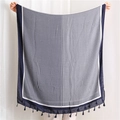 Close-up of geometric diamond pattern on navy blue and grey cotton linen scarf with tassels - Blue