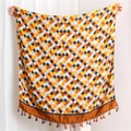 Detail of colorful plaid cotton linen scarf featuring vibrant weave and fringe tassels - Caramel color