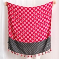 Detailed view of red bohemian cotton scarf with geometric star patterns and tassel trim - 180x90cm / Red