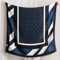 Detail view of large geometric pattern scarf with blue star print and fringe edges - Cyan Blue