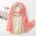 Detail of pink gradient scarf with silver foil accents next to lifestyle props - Pink & Beige