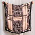 Detailed close-up of leopard print and gold chain patterns on a soft cotton linen scarf - Coffee Pink