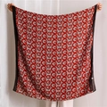 Close-up of red and white cotton linen scarf showing geometric G-letter print texture - Red