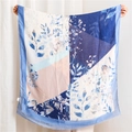 Pastel cotton linen scarf with floral print and frayed edges shown in a full-spread view - 180x90cm / Blue