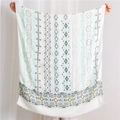 Macro view of Indian style cotton linen scarf with paisley pattern and tassel edges - Green