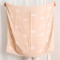 Peach-colored square scarf featuring white geometric diamond patterns and tassel edges - Khaki
