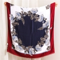 Detail of floral printed linen scarf featuring vintage patterns and fine fringe edges - Navy Blue