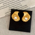 Macro detail of French vintage shell texture earrings with glossy white pearl center - Matte Gold Stud Earrings