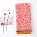 Detail of coral orange leopard print scarf with pleated texture and striped hem edges - Pink