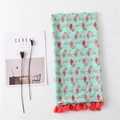 Detailed flat lay of mint green scarf with flamingo print and red fringe tassels - Mint Green