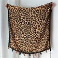 Detail of leopard print scarf featuring soft cotton-linen texture and black fringe tassels - Brown
