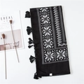 Close-up of geometric pattern scarf with fringe and minimalist lifestyle props - Black