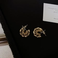 Golden irregular C-shape hoop earrings featuring a vintage spiral textured wire design - Gold