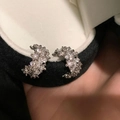 Elegant silver C-shaped hoop earrings with shimmering cubic zirconia on black velvet - Silver