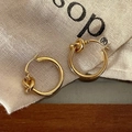 Minimalist gold knot hoop earrings featuring a polished finish and a secure snap closure - Gold Smooth Twisted Knot Earring (A-427)